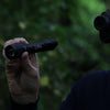 Nightfox XC5 940nm Low Glow Infrared LED Flashlight in action held with one hand and used together with a NV Monocular