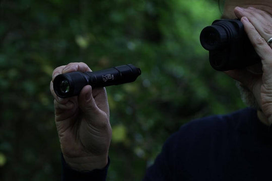 Nightfox XC5 940nm Low Glow Infrared LED Flashlight in action held with one hand and used together with a NV Monocular