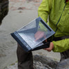 A waterproof clipboard used on a rainy beach